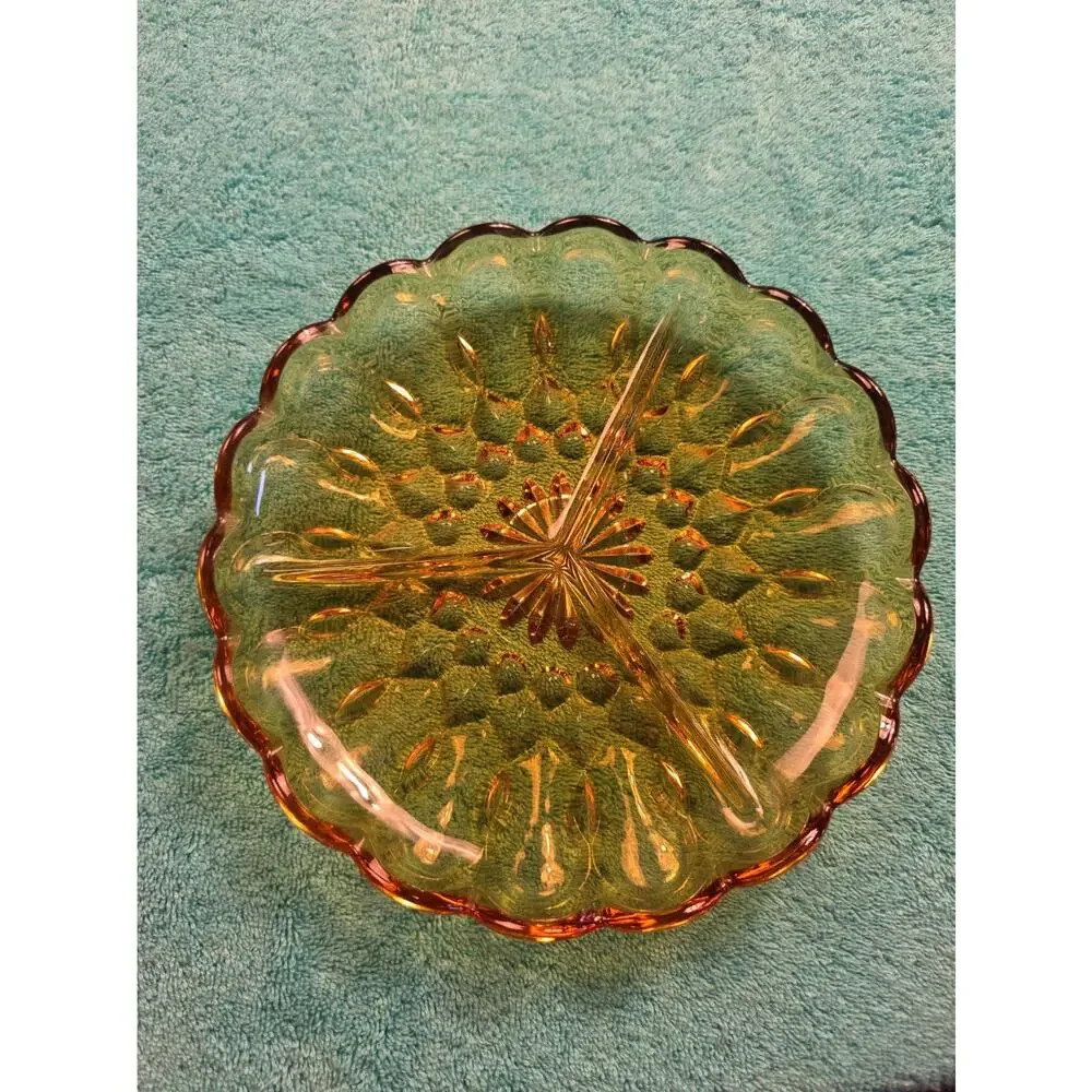 Vintage amber glass divided relish dish with pressed floral pattern.